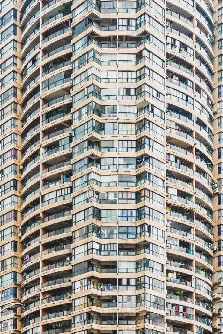 https://us.images.westend61.de/0001424643pw/exterior-shot-of-residential-condominium-house-with-endless-number-of-apartments-chongqing-china-ADSF06149.jpg